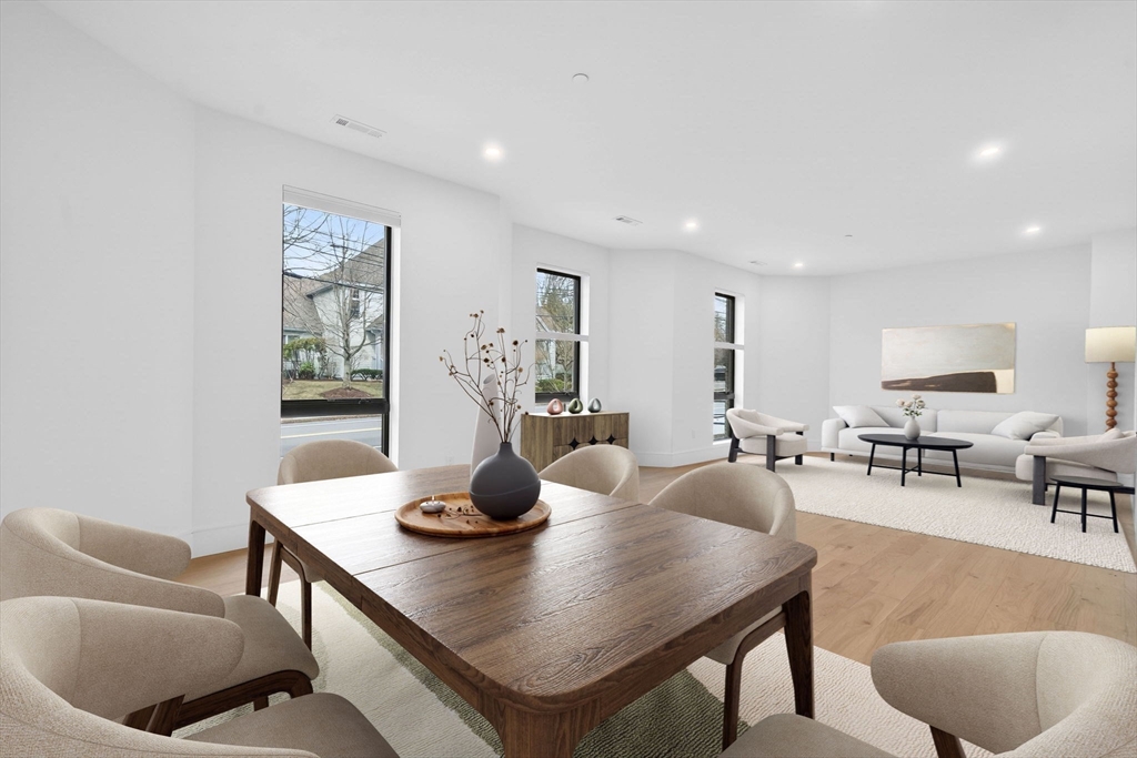 1114 Beacon Street, Unit 101 Newton, MA 02461 - Photo 4 of 29 a view of a dining room with furniture and wooden floor