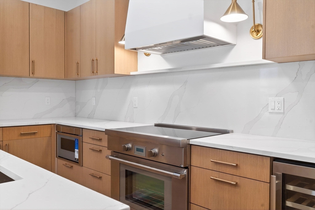 1114 Beacon Street, Unit 101 Newton, MA 02461 - Photo 6 of 29 a view of a storage and utility room with washer and dryer