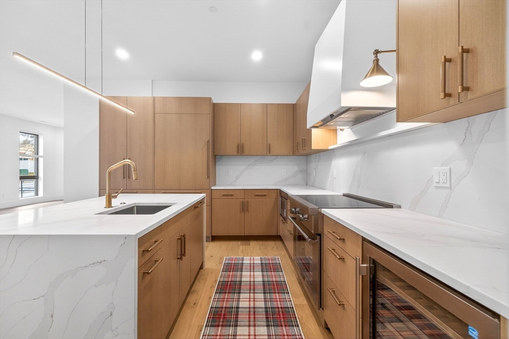 1114 Beacon Street, Unit 101 Newton, MA 02461 - Photo 7 of 29 a kitchen with a sink and a stove top oven