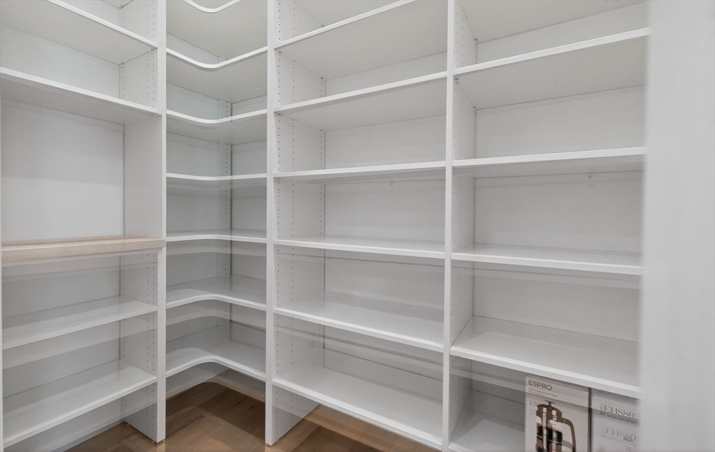 1114 Beacon Street, Unit 101 Newton, MA 02461 - Photo 8 of 29 a view of an empty room with empty racks