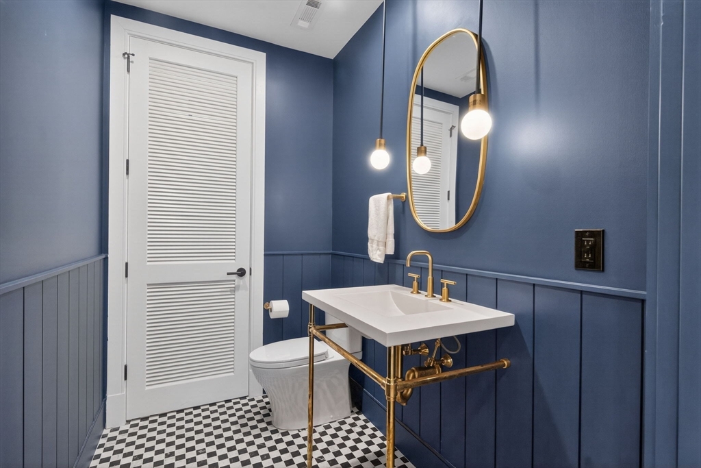 1114 Beacon Street, Unit 101 Newton, MA 02461 - Photo 10 of 29 a bathroom with a sink a toilet and a mirror