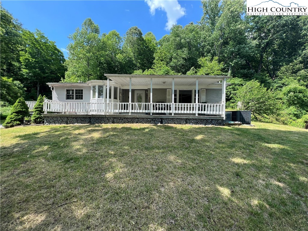 455 Willowdale Church Road Vilas, NC 28692 - Photo 11 of 14 a front view of house with yard and green space