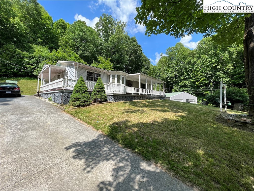 455 Willowdale Church Road Vilas, NC 28692 - Photo 2 of 14 a house view with a sitting space and garden