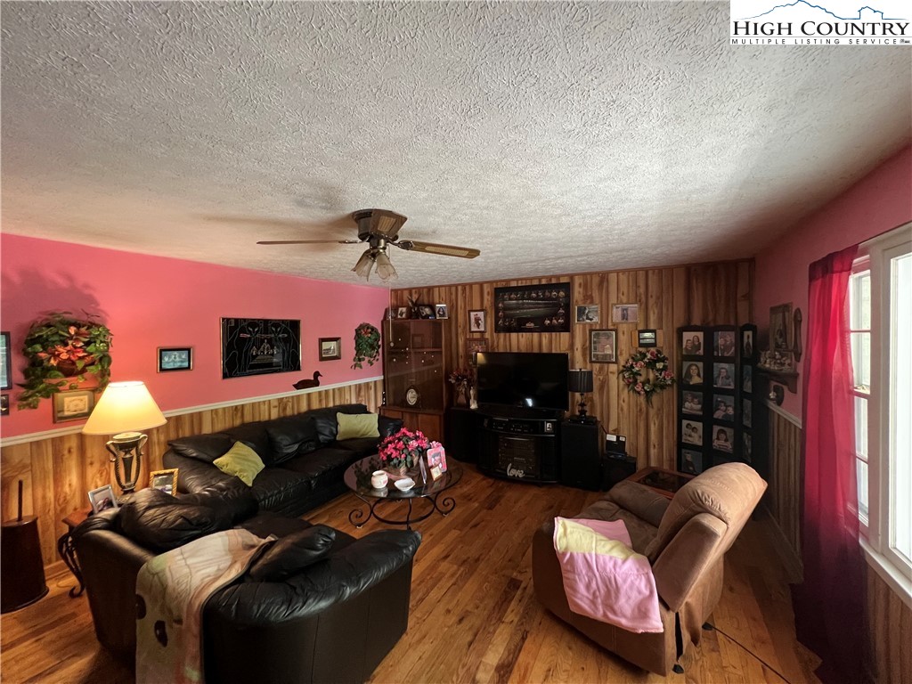 455 Willowdale Church Road Vilas, NC 28692 - Photo 5 of 14 a living room with furniture a lamp and a bookshelf