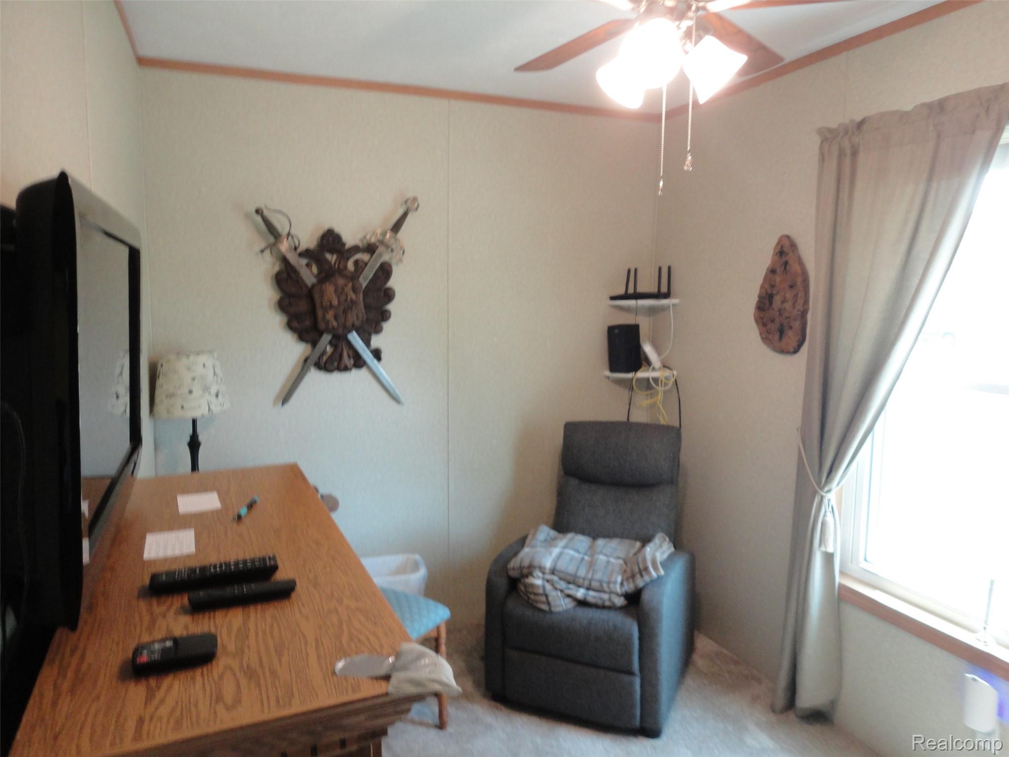 463 Edinborough Temperance, MI 48182 - Photo 10 of 23 Bedroom Room featuring neutral wall paneling and trim, a ceiling fan with integrated lighting, and carpet flooring