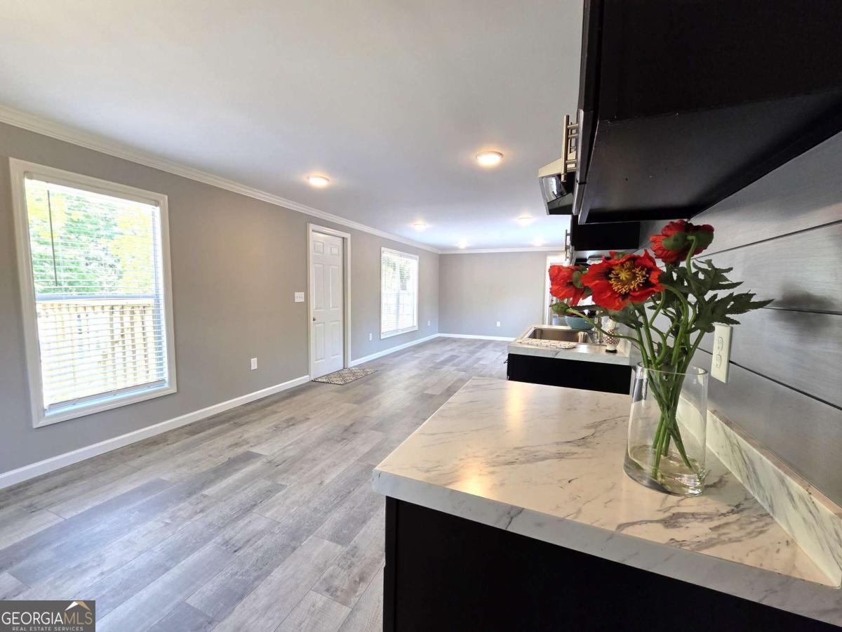 956 Donaldson Street Metter, GA 30439 - Photo 14 of 49 a view of a living room with furniture and flowers