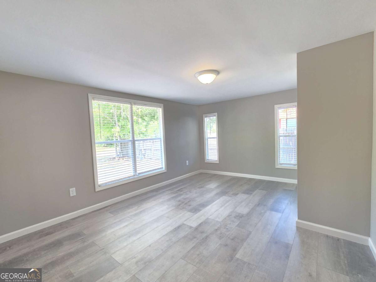 956 Donaldson Street Metter, GA 30439 - Photo 21 of 49 an empty room with windows and closet