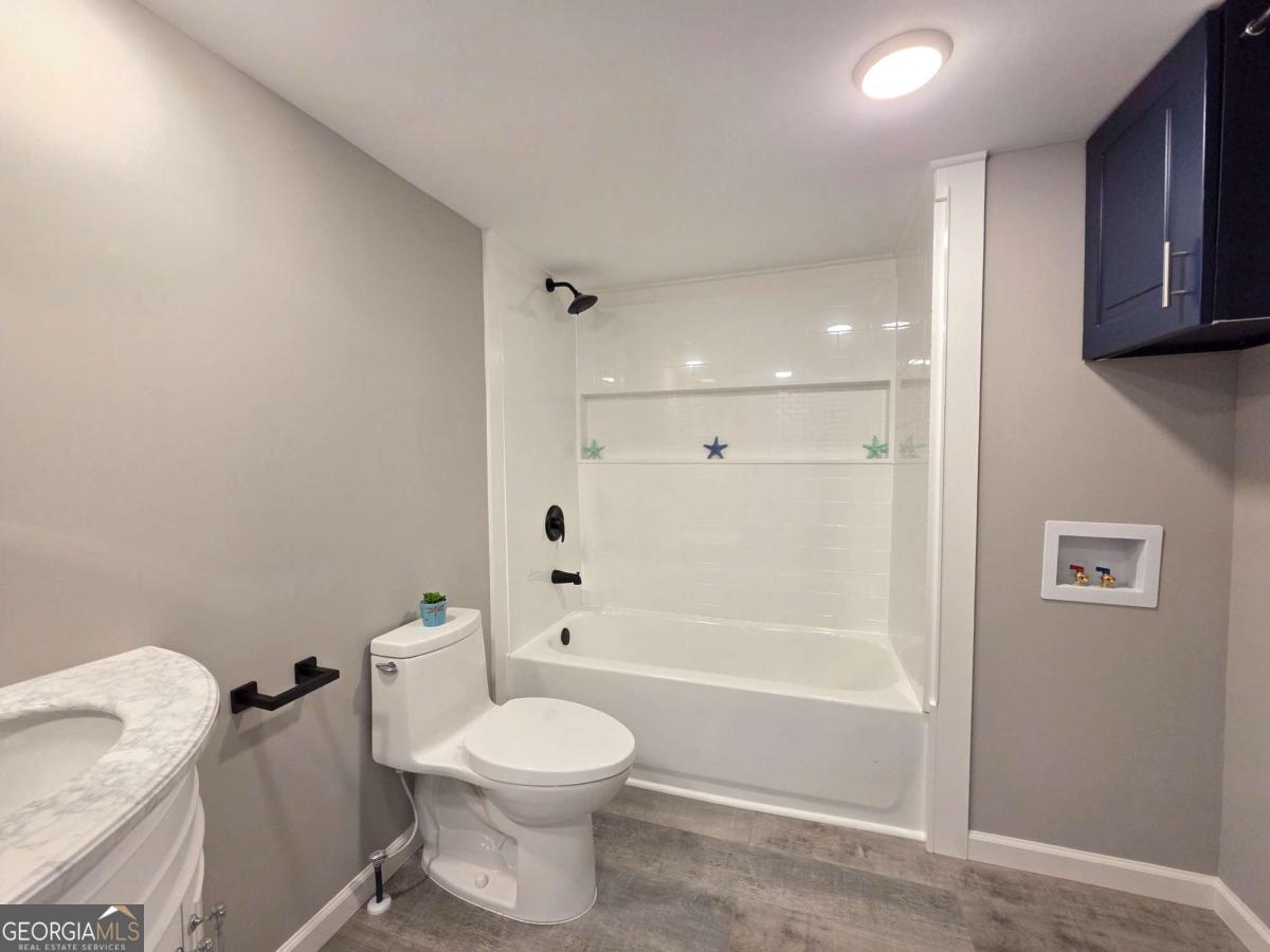 956 Donaldson Street Metter, GA 30439 - Photo 24 of 49 a bathroom with a toilet and shower