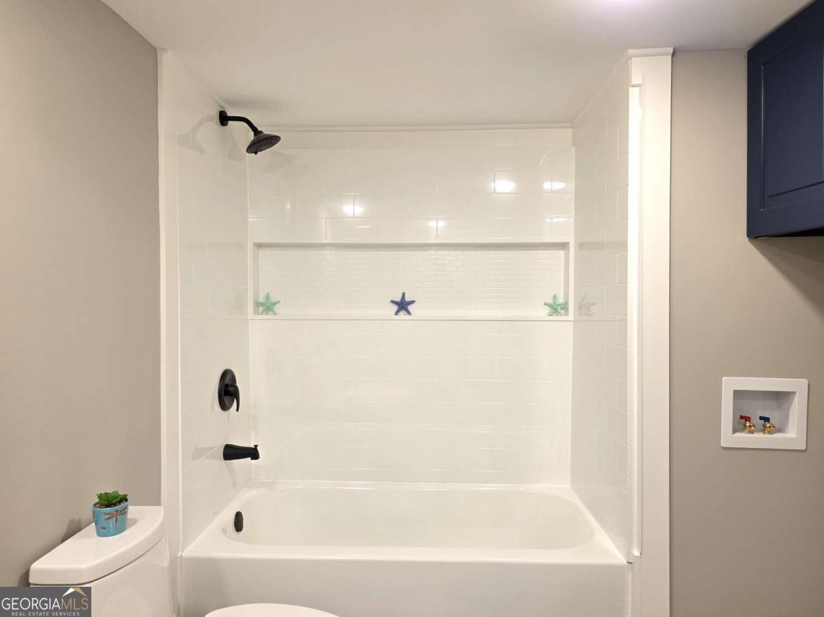 956 Donaldson Street Metter, GA 30439 - Photo 25 of 49 a bathroom with a bathtub and a shower