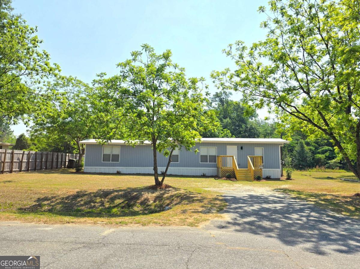 956 Donaldson Street Metter, GA 30439 - Photo 5 of 49 a swimming pool with outdoor seating and yard