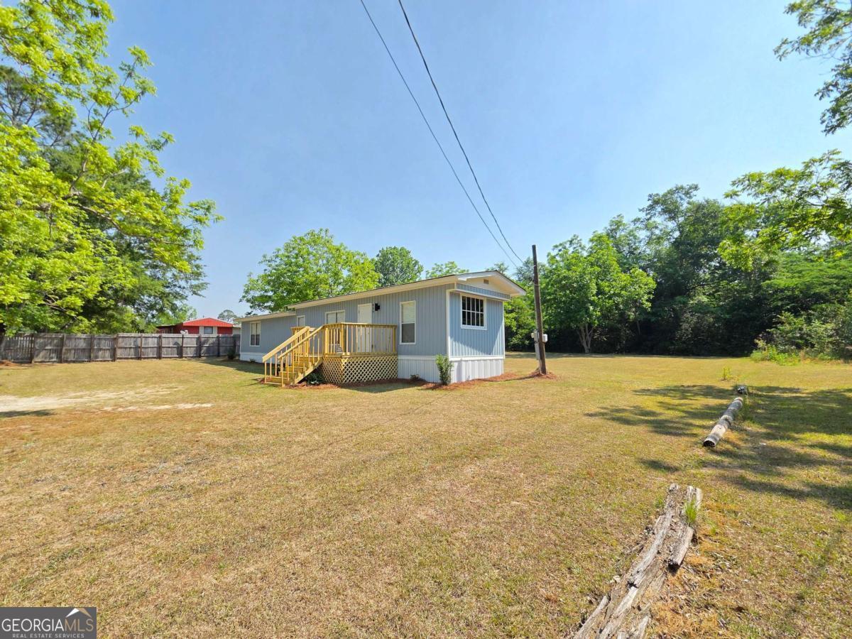 956 Donaldson Street Metter, GA 30439 - Photo 6 of 49 a house with trees in front of it