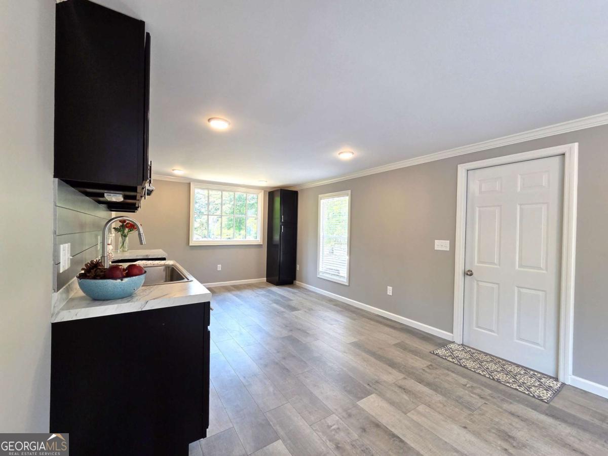 956 Donaldson Street Metter, GA 30439 - Photo 7 of 49 a kitchen with sink and window
