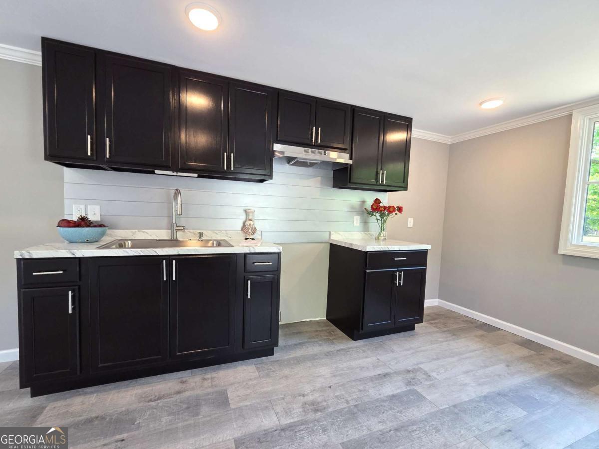 956 Donaldson Street Metter, GA 30439 - Photo 9 of 49 a kitchen with stainless steel appliances granite countertop a refrigerator and a stove top oven