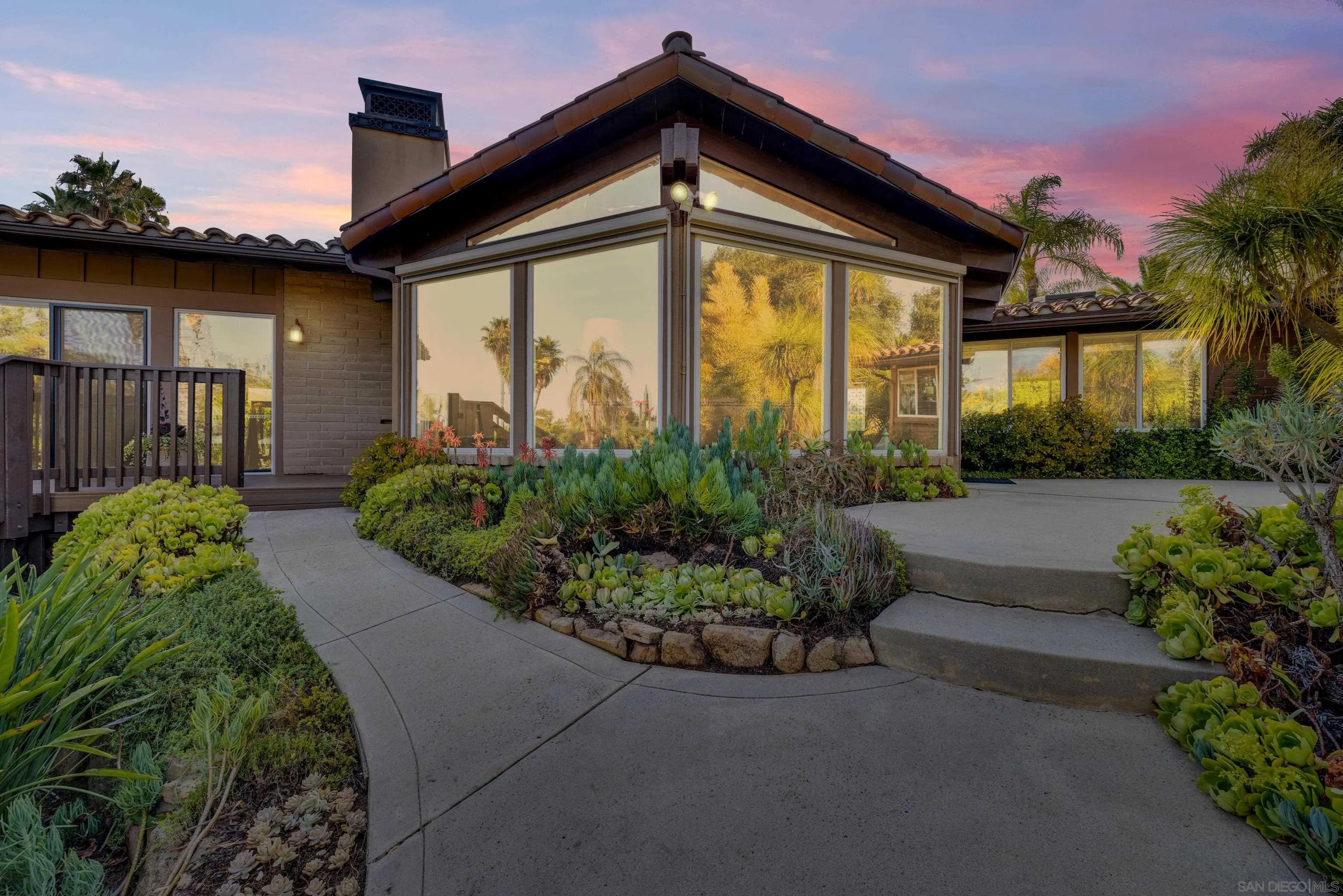 a front view of a house with a garden