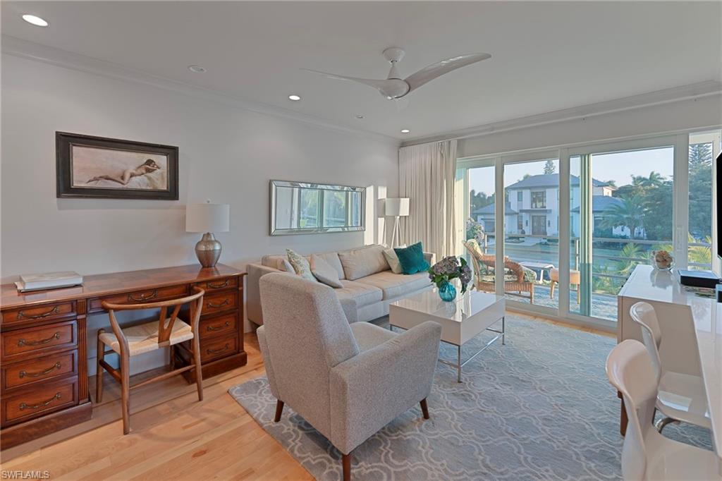 291A 8th Avenue South, Unit 291B Naples, FL 34102 - Photo 4 of 10 Living room with light wood-style floors, ornamental molding, recessed lighting, a ceiling fan, and a desk