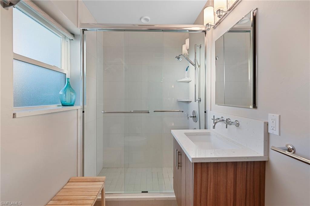 291A 8th Avenue South, Unit 291B Naples, FL 34102 - Photo 7 of 10 Bathroom with vanity and a shower stall