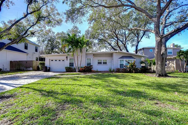 a front view of house with yard and trees