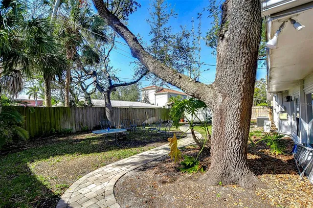 a backyard of a house with lots of green space and fountain