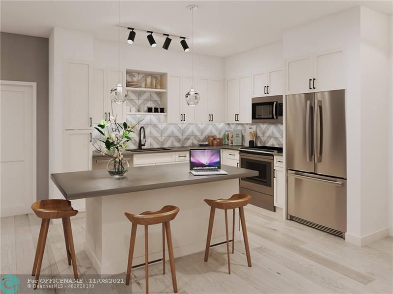 a kitchen with stainless steel appliances a dining table chairs and refrigerator