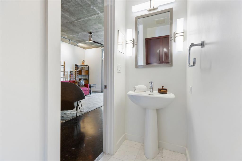 3030 Bryan Street, Unit 409 Dallas, TX 75204 - Photo 11 of 30 a bathroom with a sink and mirror