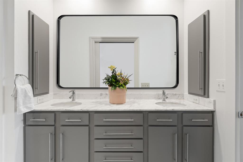3030 Bryan Street, Unit 409 Dallas, TX 75204 - Photo 16 of 30 a bathroom with a double vanity sink and a mirror