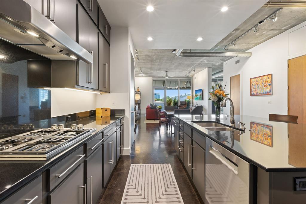 3030 Bryan Street, Unit 409 Dallas, TX 75204 - Photo 4 of 30 a kitchen with stainless steel appliances granite countertop a stove and a sink