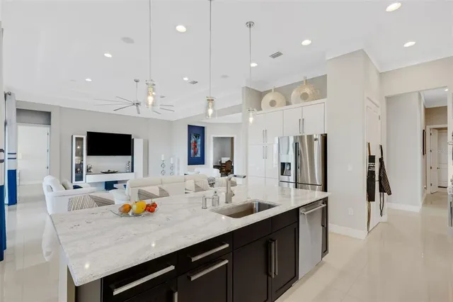 a kitchen with a refrigerator and two windows