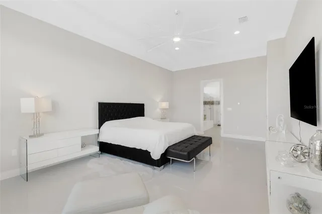 a bathroom with a granite countertop sink mirror vanity and toilet