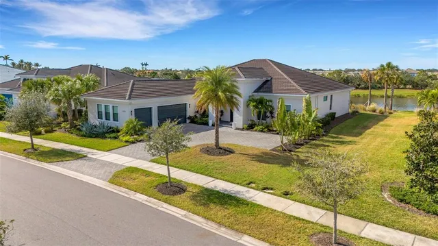 a living room with furniture ceiling fan and a large window