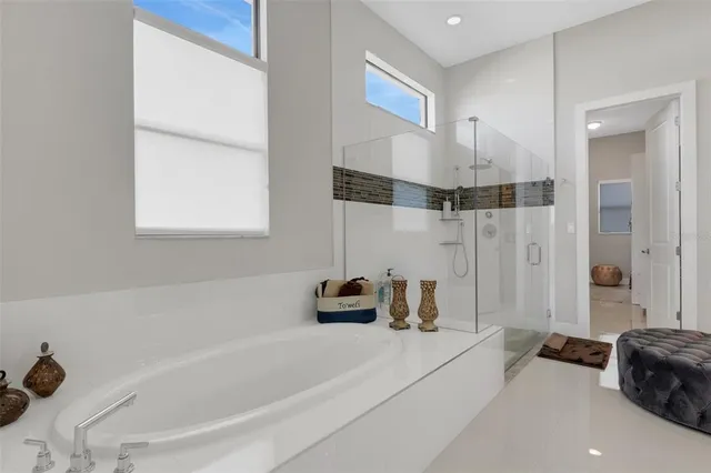 a bedroom with furniture and a large window