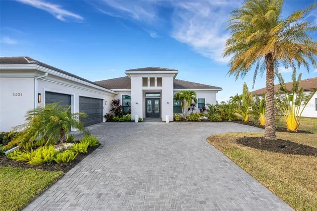 a living room with furniture ceiling fan and a large window