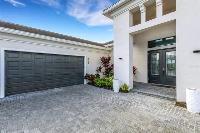 a living room with furniture a flat screen tv and a large window