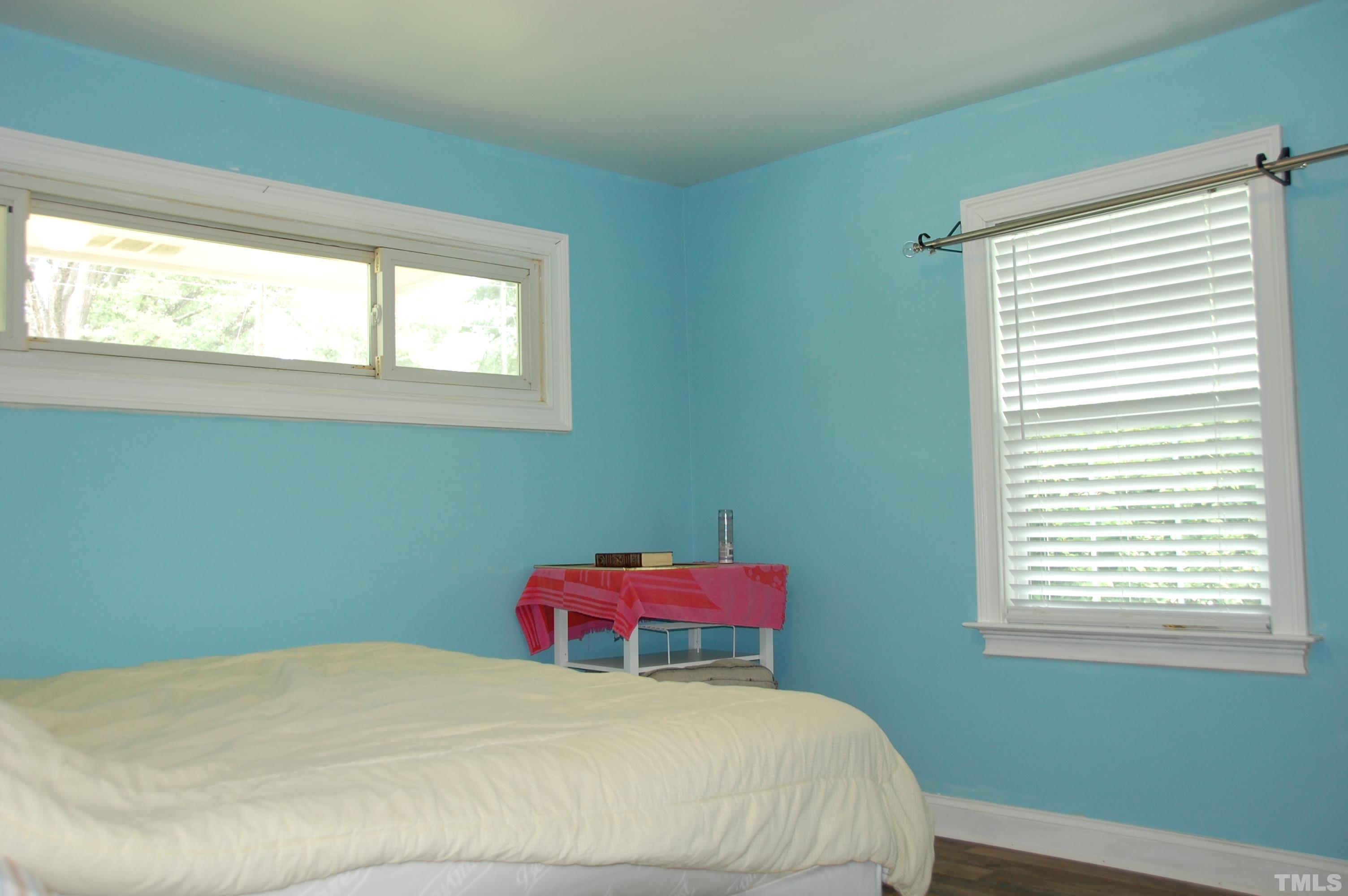 2406 Boswell Road Raleigh, NC 27610 - Photo 14 of 21 a bedroom with a bed and a window