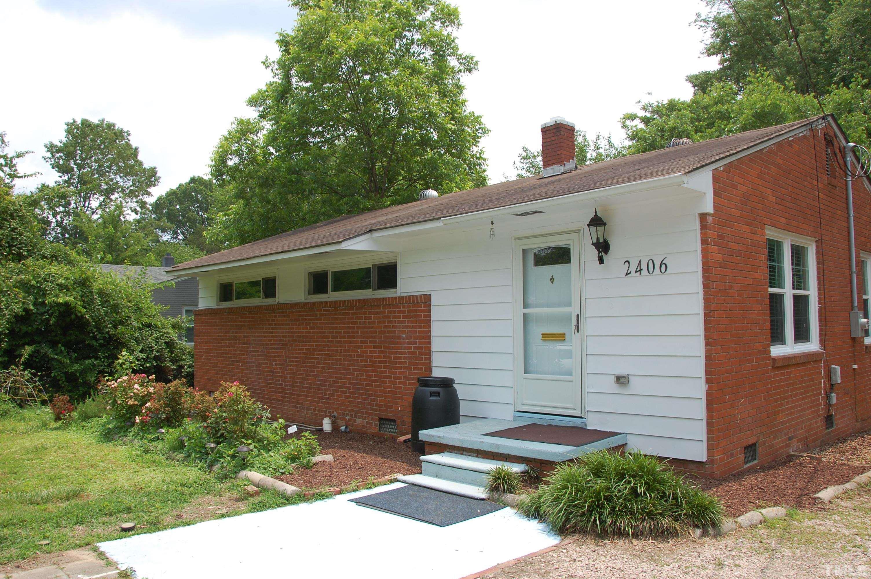 2406 Boswell Road Raleigh, NC 27610 - Photo 3 of 21 a front view of a house with a yard and garage