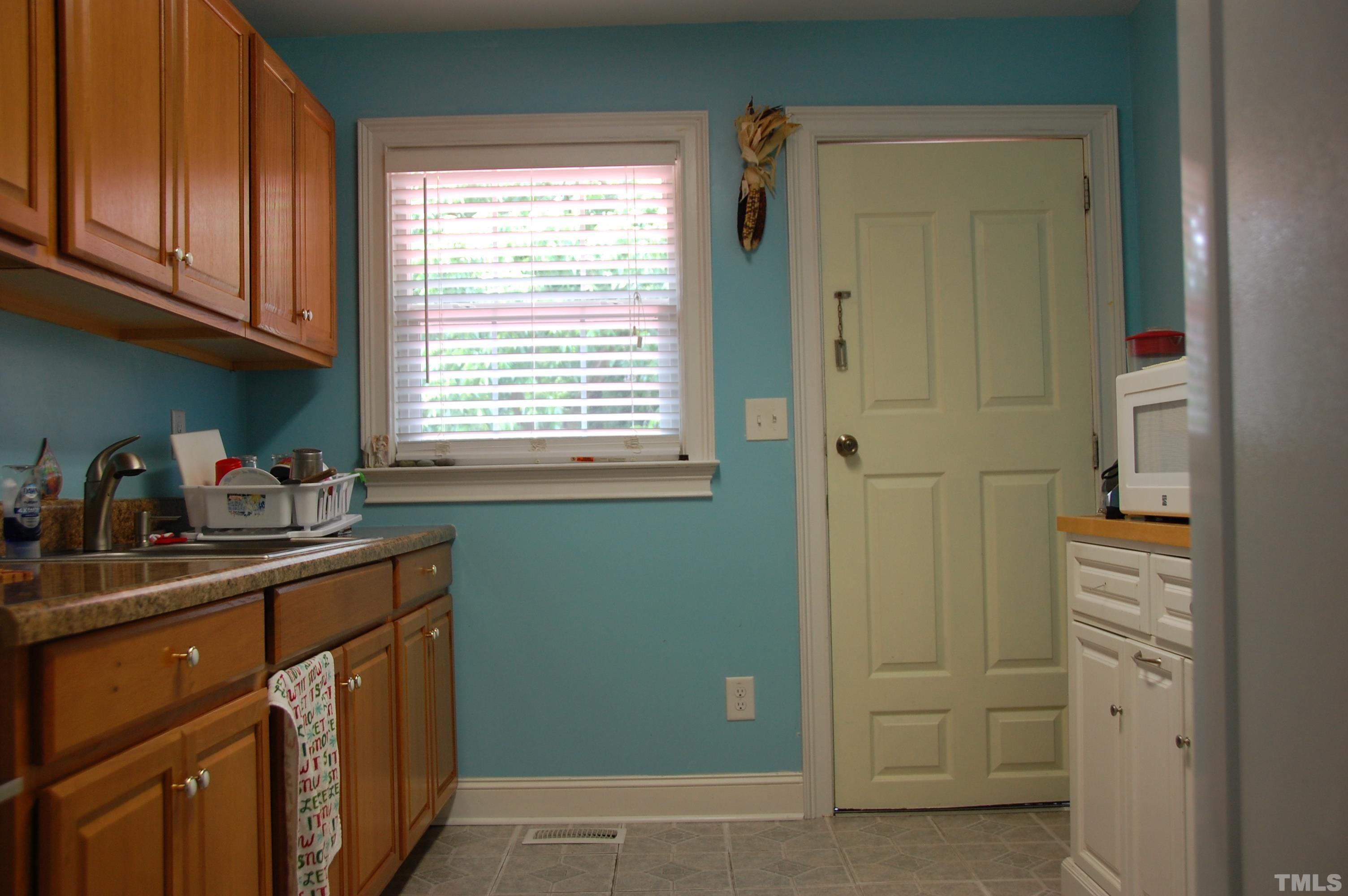 2406 Boswell Road Raleigh, NC 27610 - Photo 10 of 21 a kitchen with a sink cabinets and a window