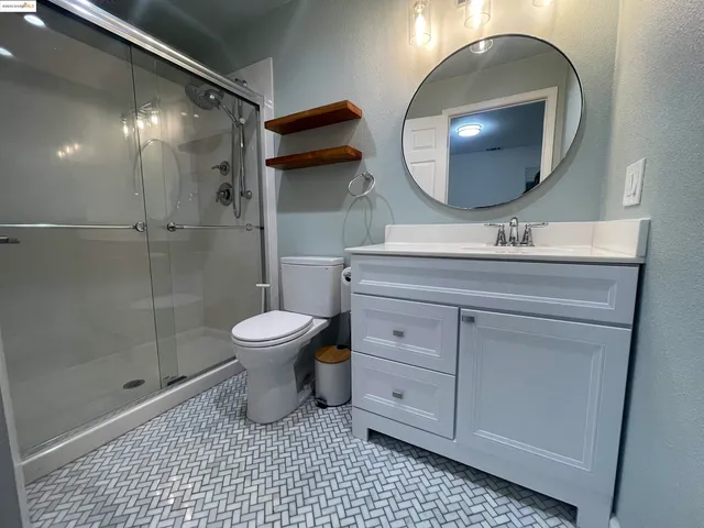a bathroom with a toilet a sink and mirror