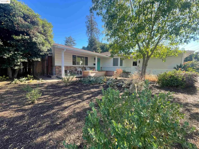 a backyard of a house with yard and outdoor seating