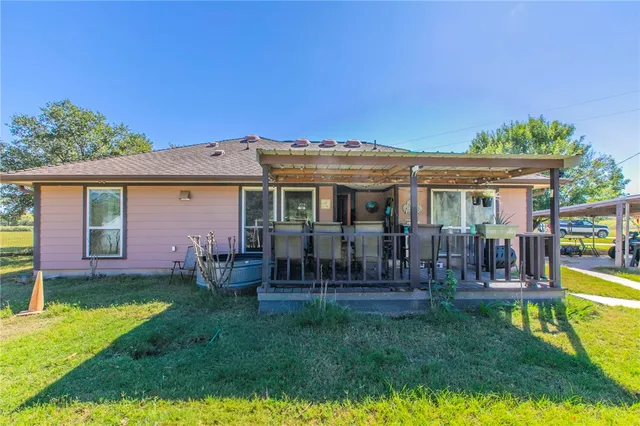 a view of a house with a yard porch and sitting area