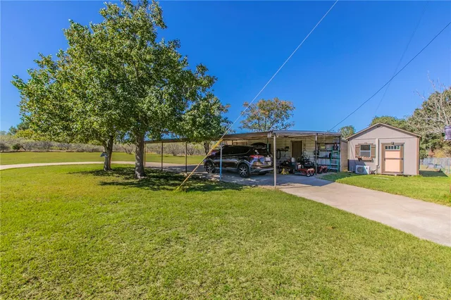 a view of a house with pool and a garden