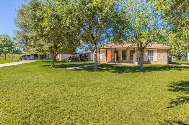 a front view of house with yard and trees