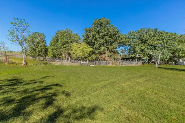 a view of a garden with a building in the background