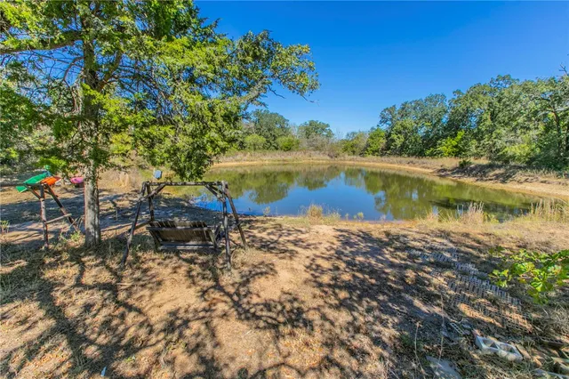 a view of a lake with houses in the back