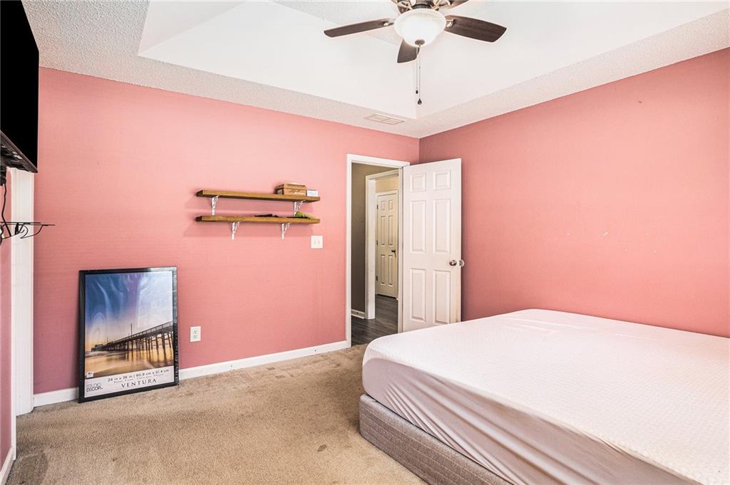 1224 Dylan Way Bethlehem, GA 30620 - Photo 23 of 33 a bedroom with a bed and a chandelier