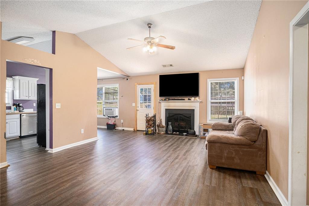 1224 Dylan Way Bethlehem, GA 30620 - Photo 5 of 33 a living room with furniture and a fireplace or television