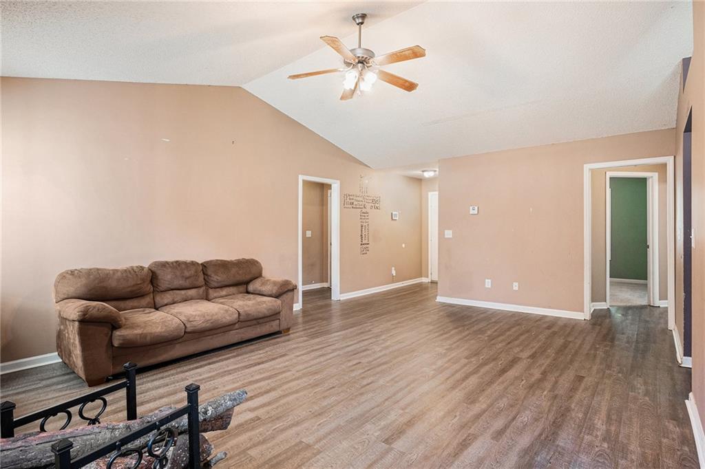 1224 Dylan Way Bethlehem, GA 30620 - Photo 8 of 33 a living room with furniture and a wooden floor