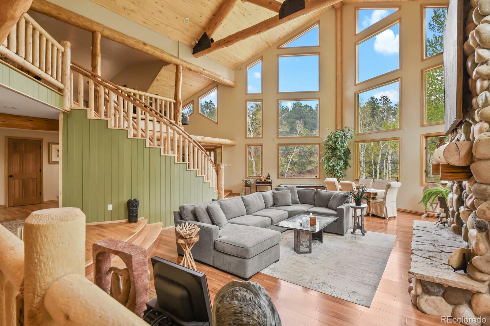 417 Witter Gulch Road Evergreen, CO 80439 - Photo 8 of 50 a living room with furniture or couch and a large window