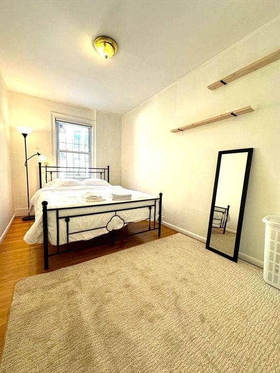 12 Follen Street, Unit ONEA Boston, MA 02116 - Photo 11 of 23 a bed room with a bed and a window