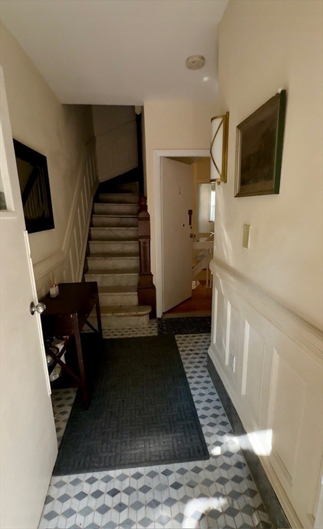 12 Follen Street, Unit ONEA Boston, MA 02116 - Photo 17 of 23 a view of a livingroom with wooden floor and stairs