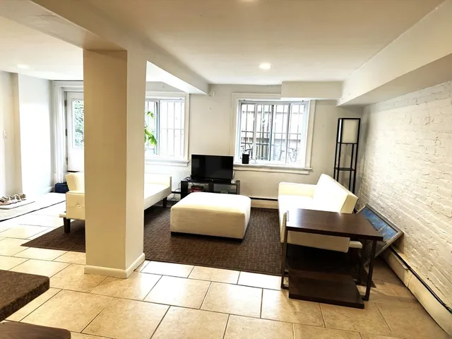 a living room with furniture and floor to ceiling windows