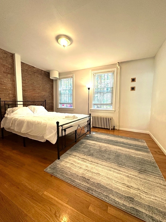 12 Follen Street, Unit ONEA Boston, MA 02116 - Photo 8 of 23 a bedroom with bed and a window